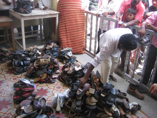 No shoes allowed in the Mysore Palace, so you have to leave your shoes out here...  Sweet system, boss...